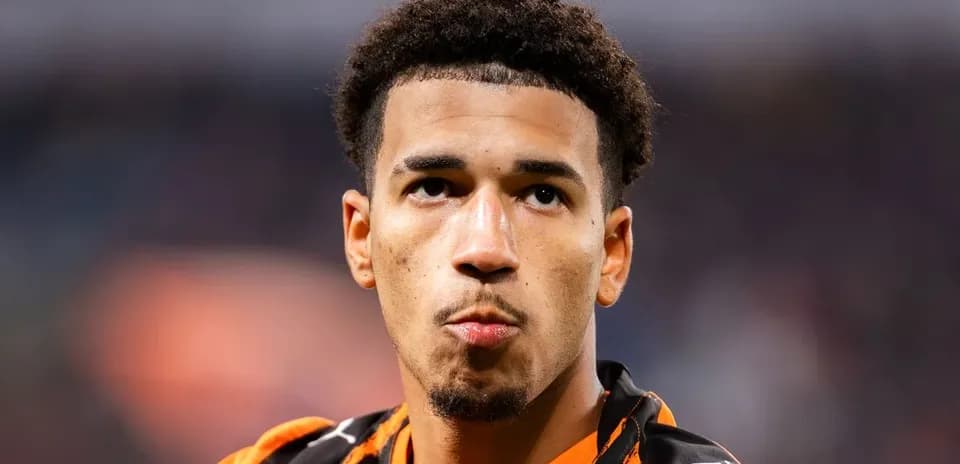 Player wearing orange jersey looking into distance