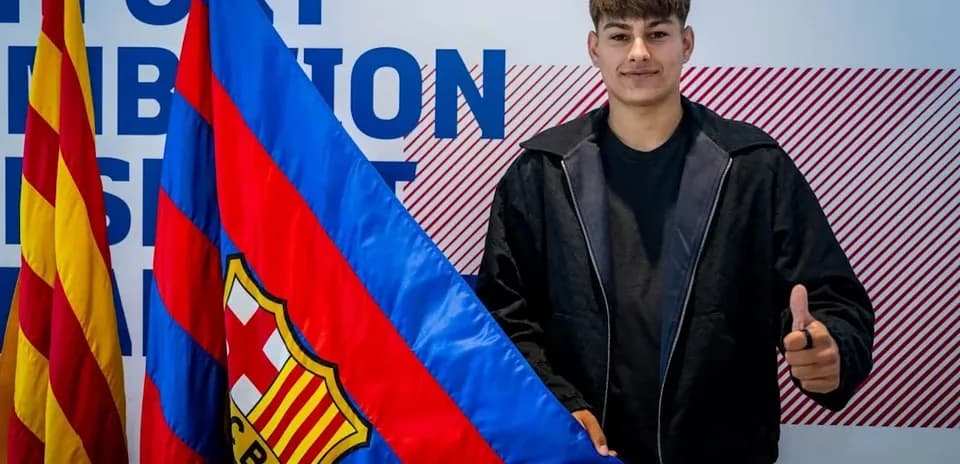 Player holding FC Barcelona flag with thumbs up