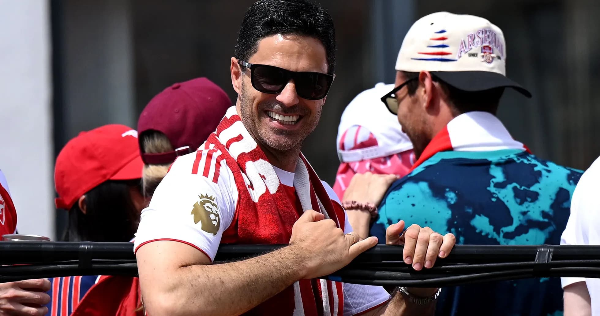 Man in sunglasses celebrating with fans at event