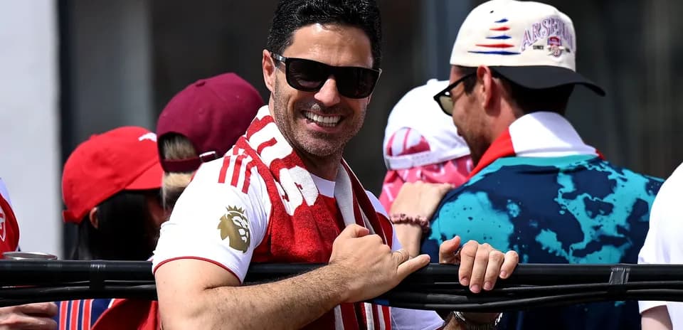 Man in sunglasses celebrating with fans at event