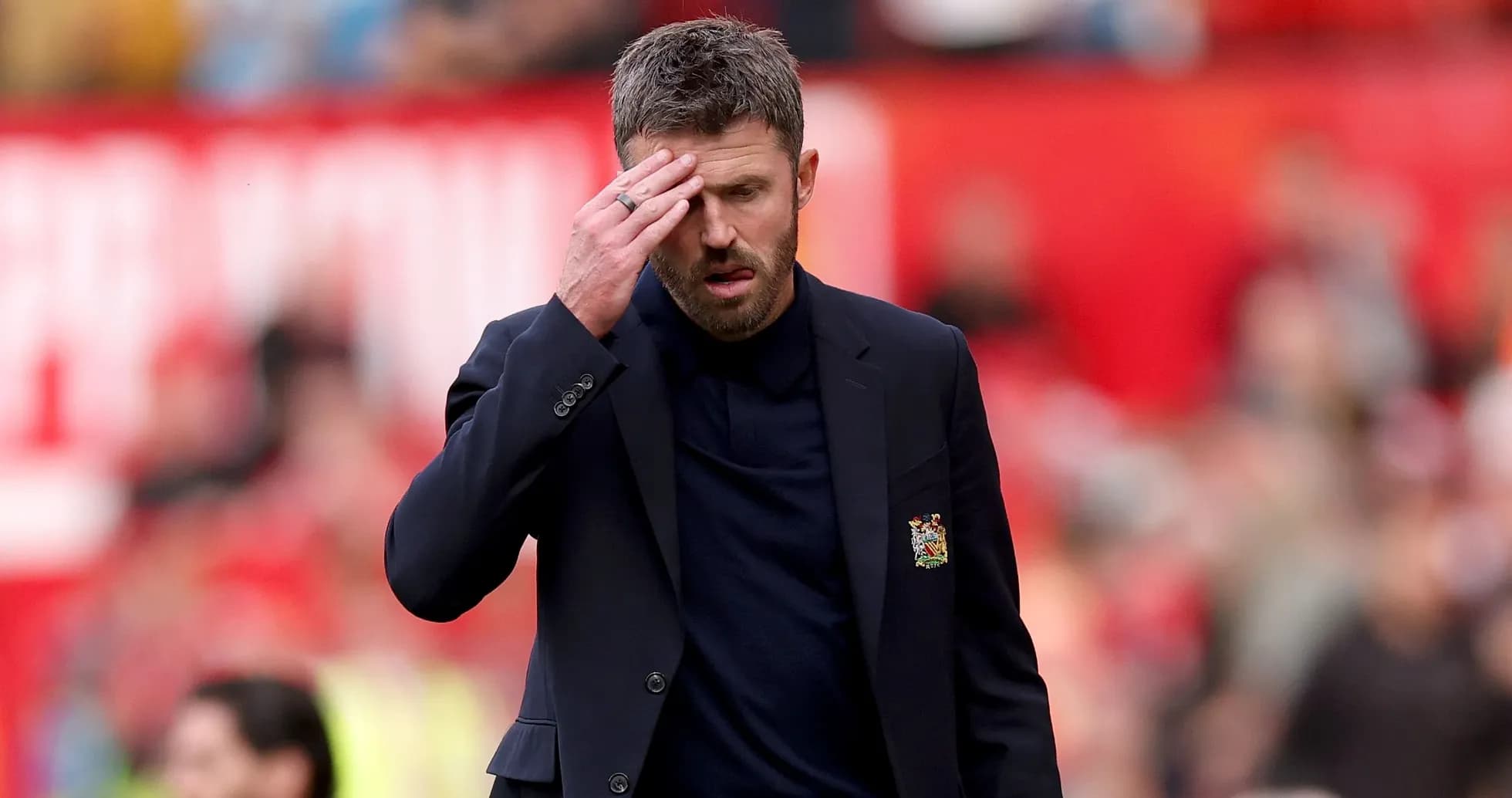 Coach looking concerned on the sidelines during match