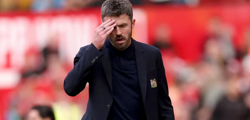 Coach looking concerned on the sidelines during match