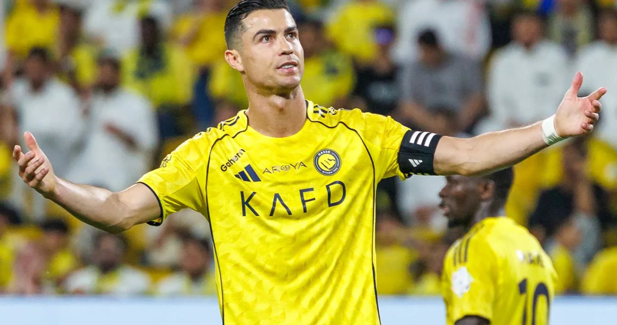 Player gesturing during match in yellow team uniform