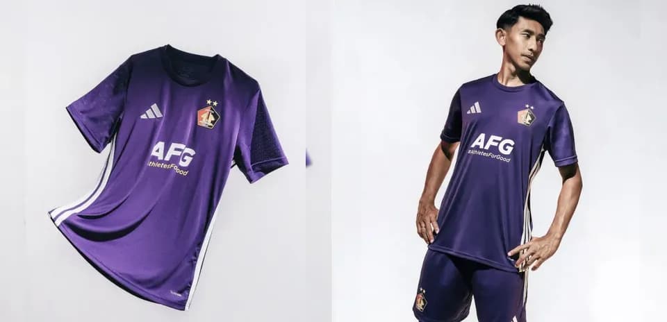 Purple football kit displayed and worn by a player