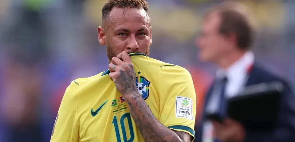 Player in Brazil jersey touching his shirt