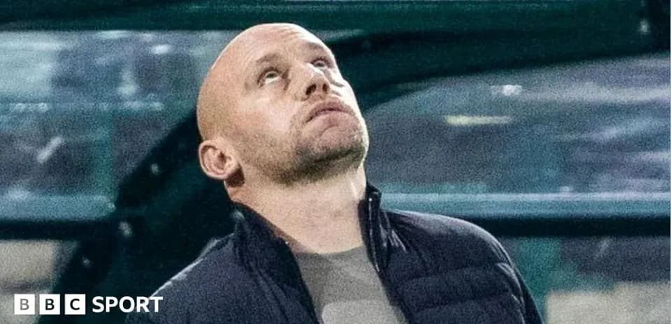 Coach looking upwards from the sidelines