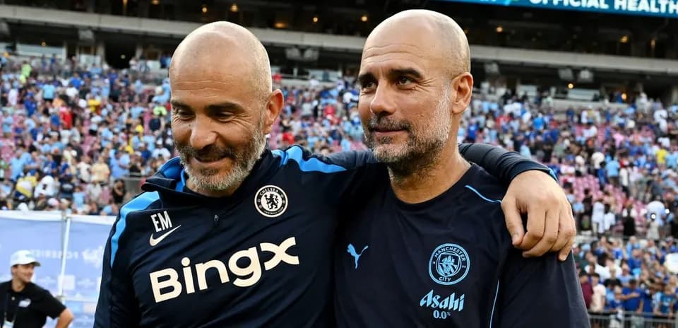 Two football coaches embracing on the field