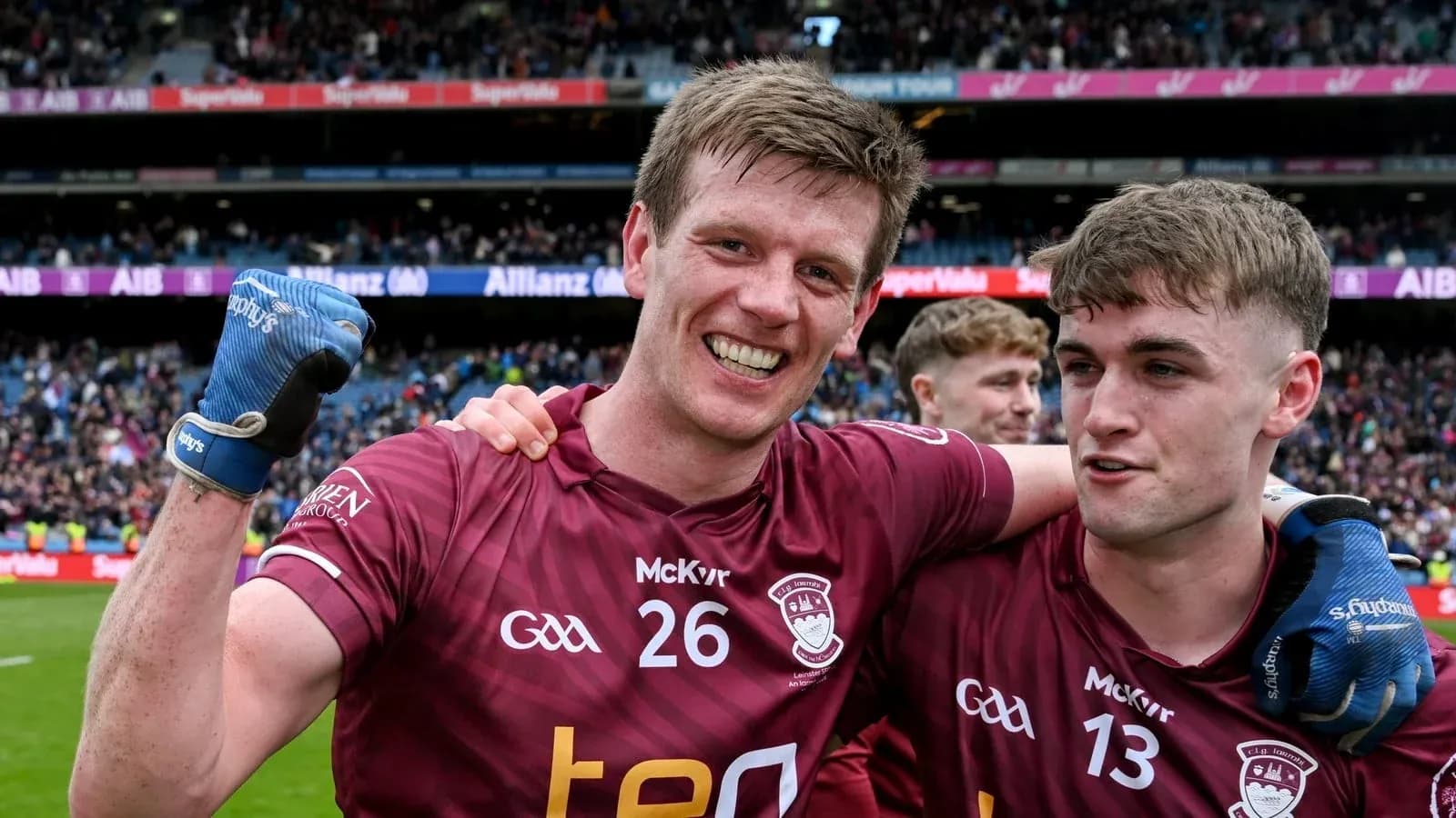 Two players celebrating on the pitch after a match