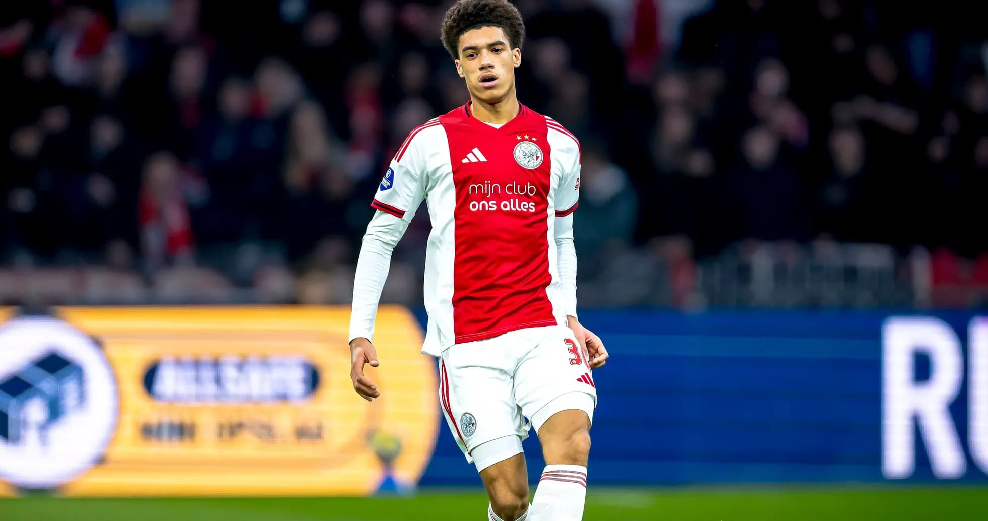 Player walking on the pitch in Ajax jersey