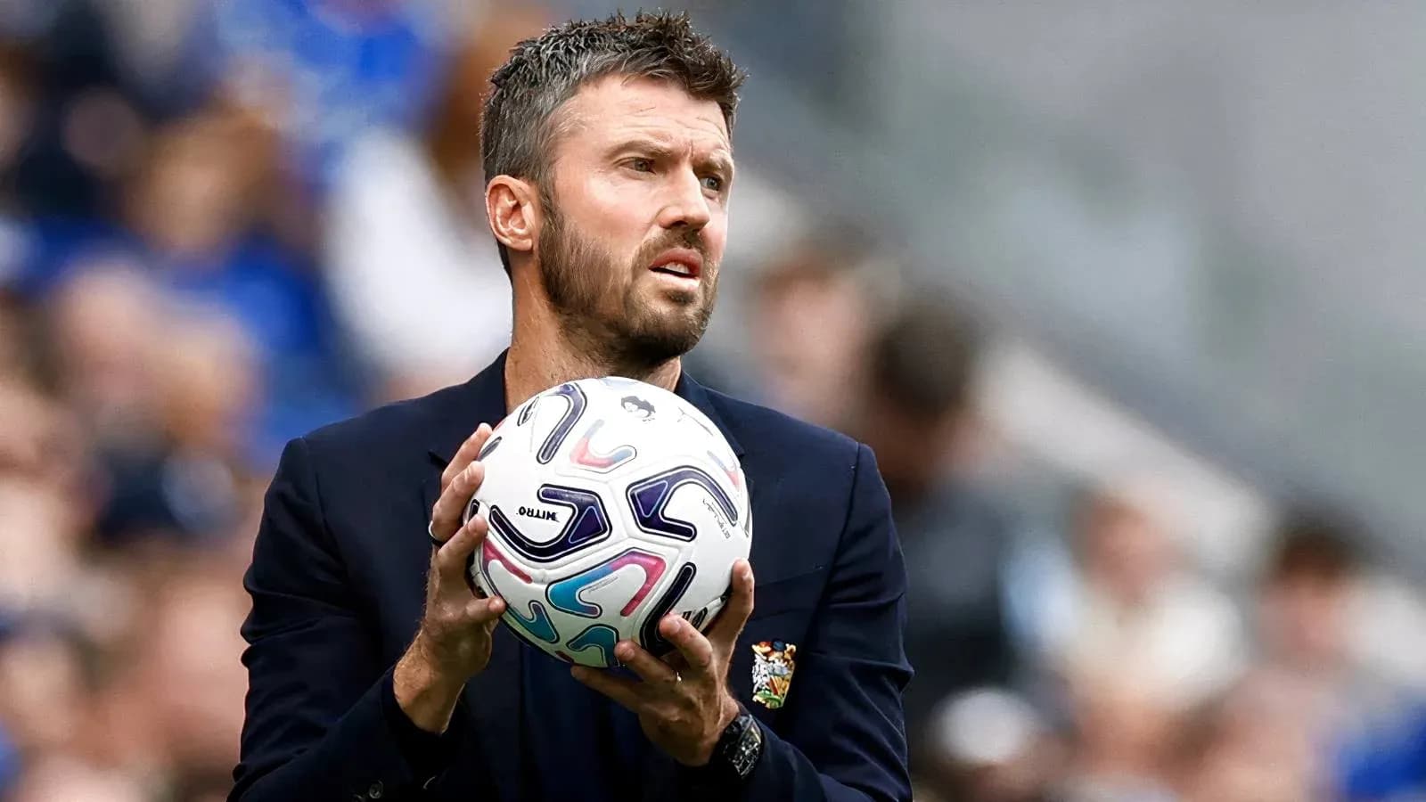 Coach holding ball during a match