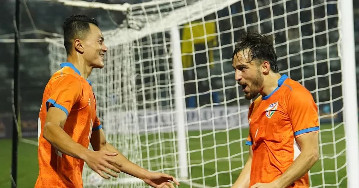Two players celebrating a goal on the field