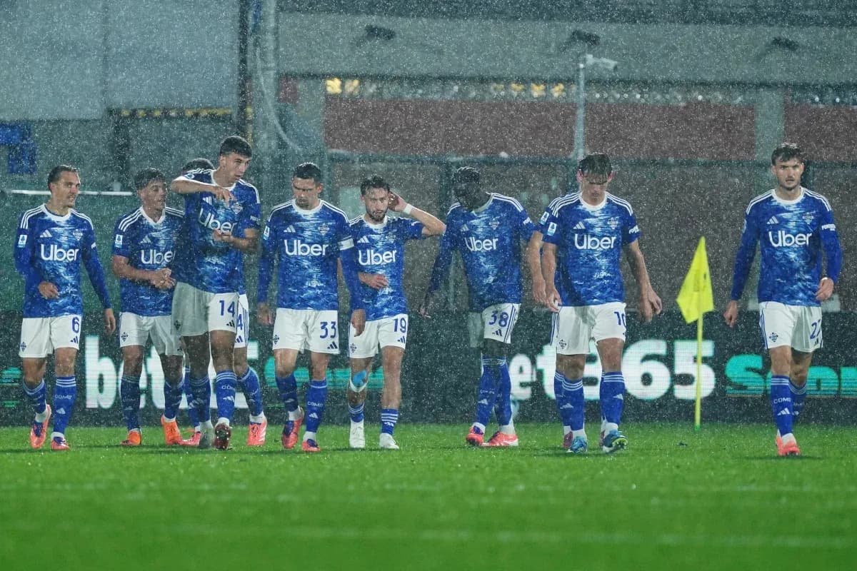 Como players walking in heavy rain during match
