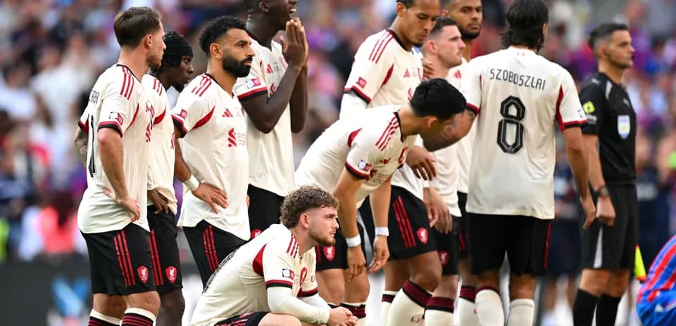 Players from Liverpool standing together during match