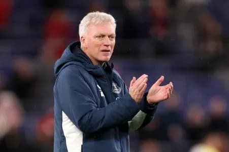 Manager clapping during match on sideline