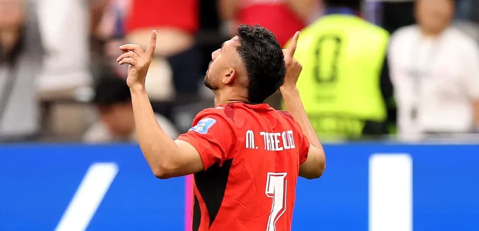 Player celebrating with arms raised after scoring