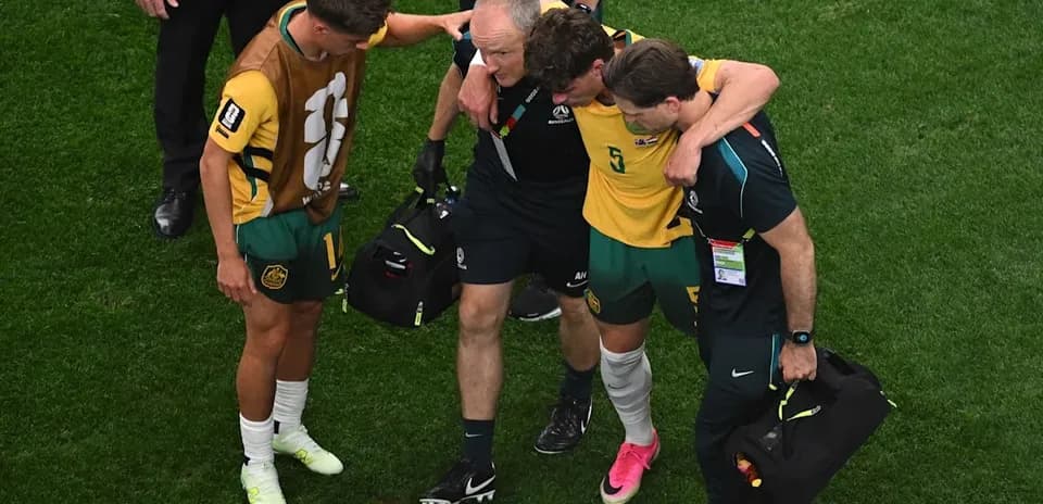 Player receiving assistance from staff after injury