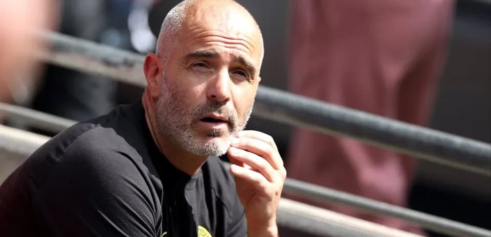 Coach sitting on bench during match observation