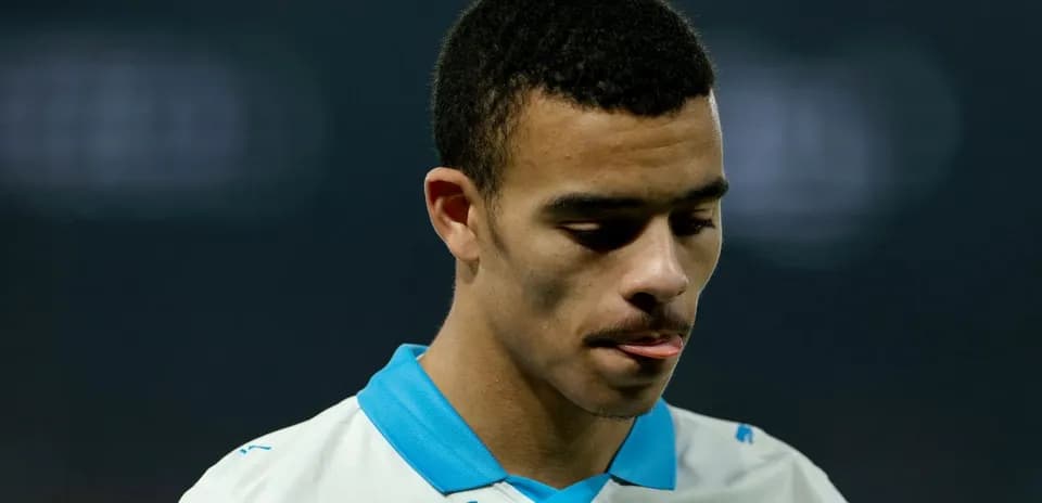 Player looking down during match in white jersey