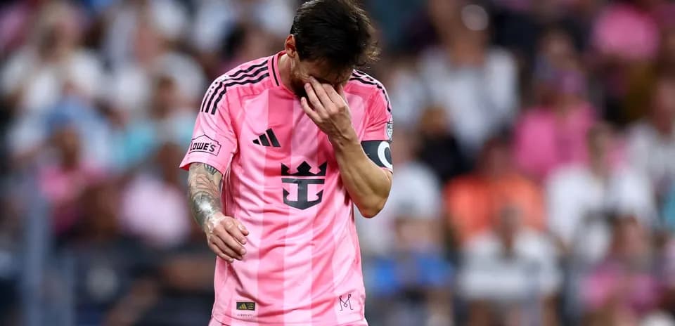 Player in pink jersey walking with head down
