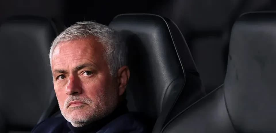 Manager seated on the bench during a match