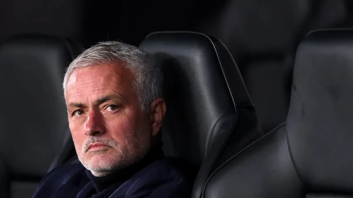 Manager seated on the bench during a match