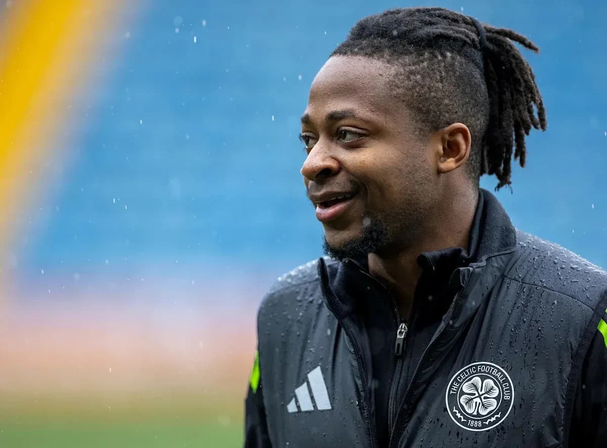 Player in Celtic Football Club jacket during rain
