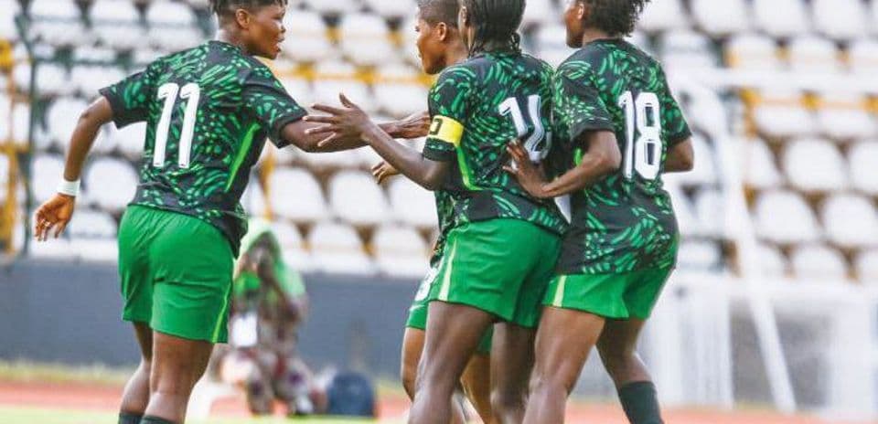 Players celebrating a goal on the field