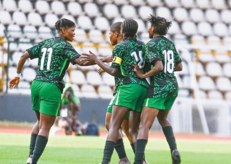 Players celebrating a goal on the field