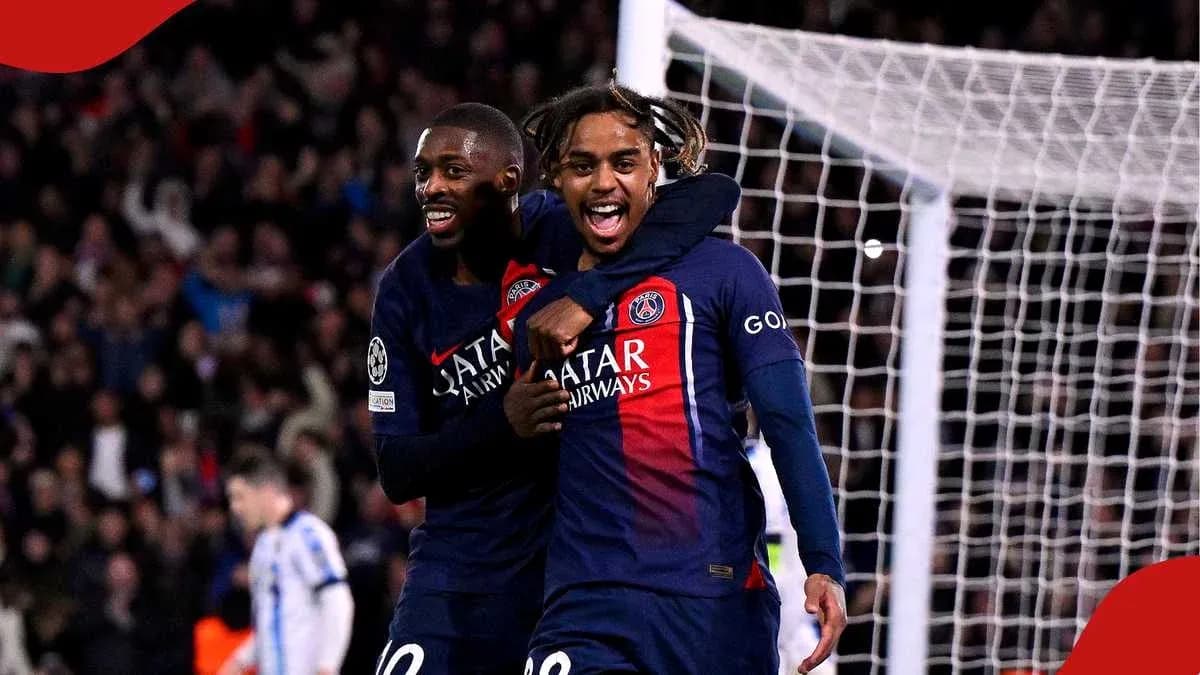 Two PSG players celebrating a goal together