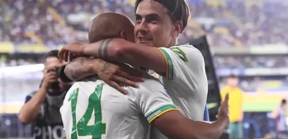 Two players embracing on the pitch after match