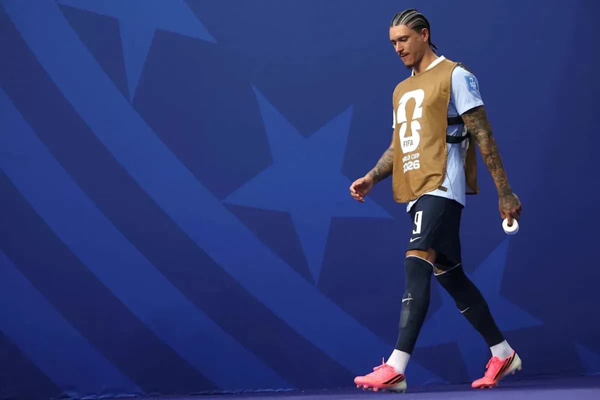 Player walking on the pitch wearing training bib