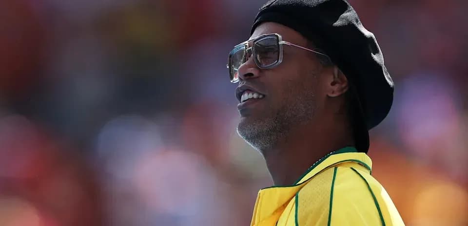 Former player wearing sunglasses and yellow jersey