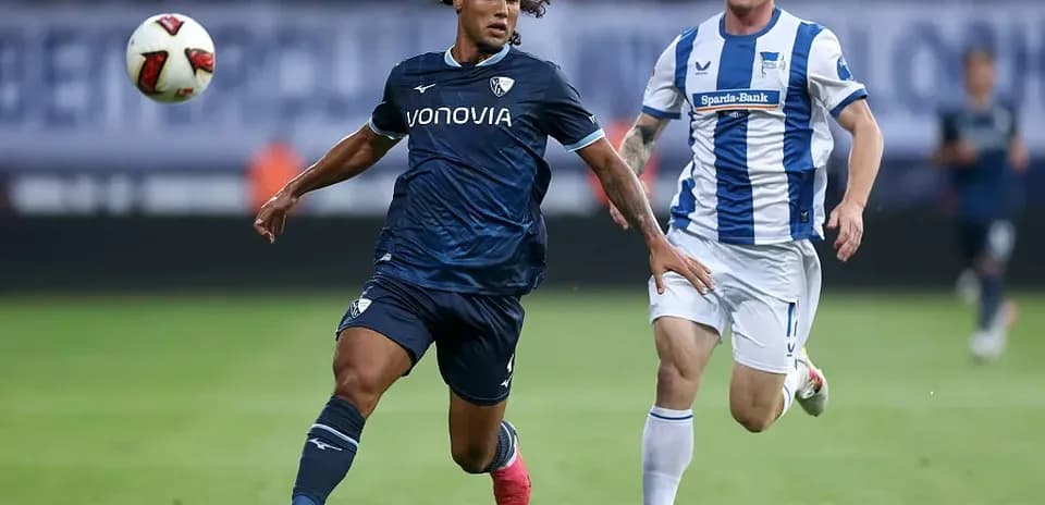 Player in blue chasing the ball during match