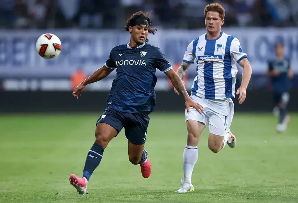 Player in blue chasing the ball during match