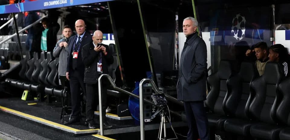 Coach observing from the sidelines during match