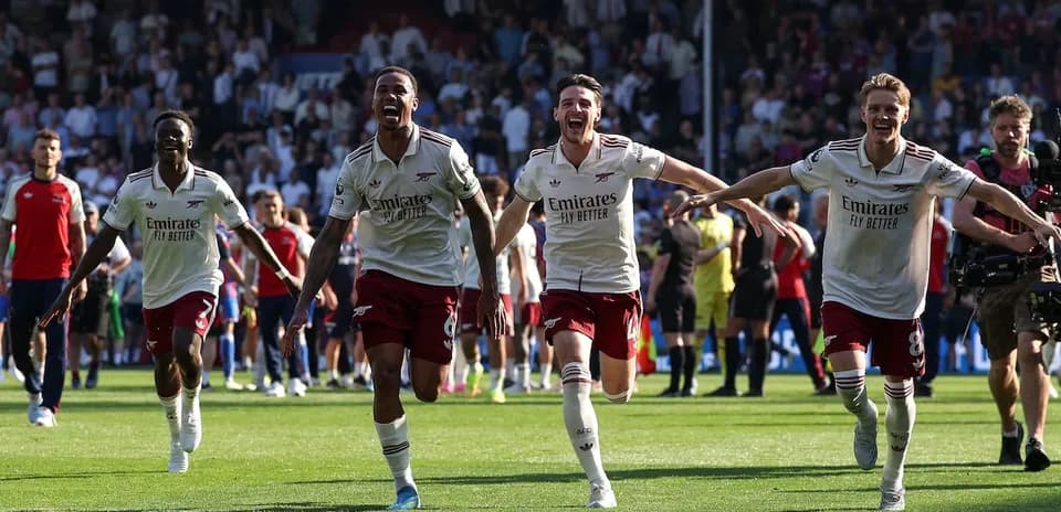 Arsenal players celebrating victory on the pitch