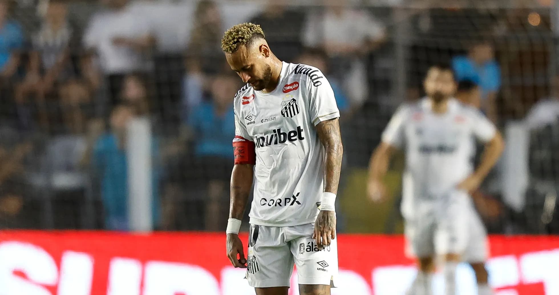 Player in Santos jersey looking down on the field