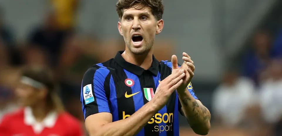 Player in blue and black jersey gesturing on field