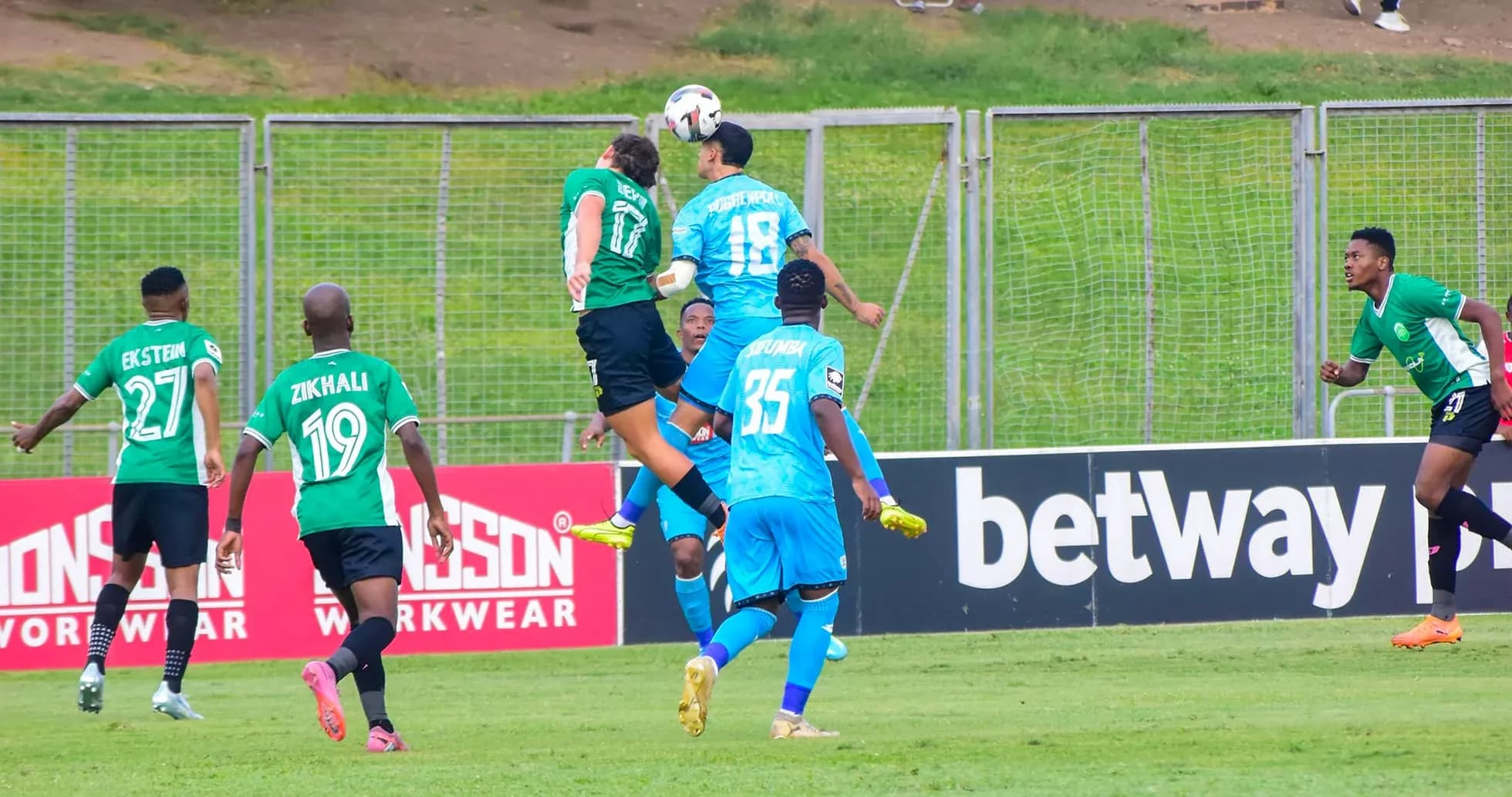 Players contesting for the ball in CAF match