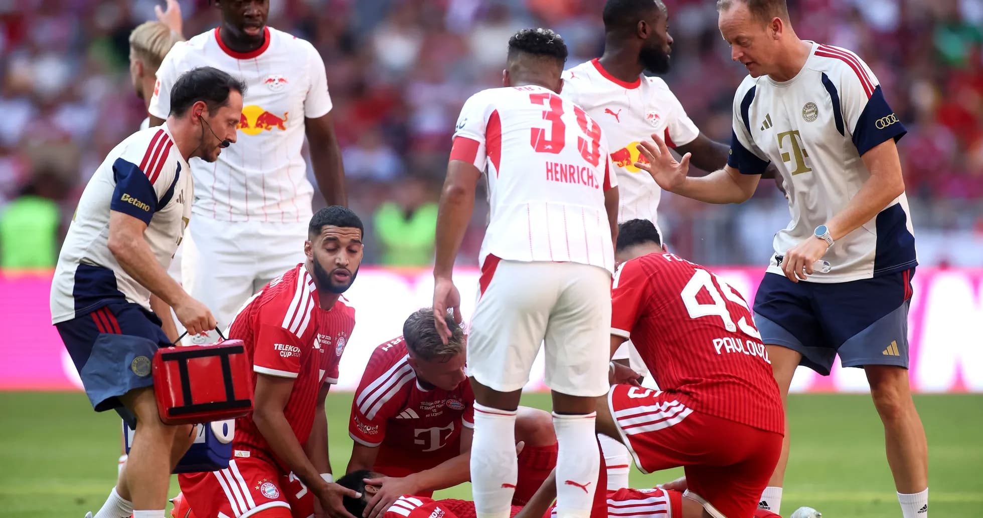 Players and medical staff attending to injured player
