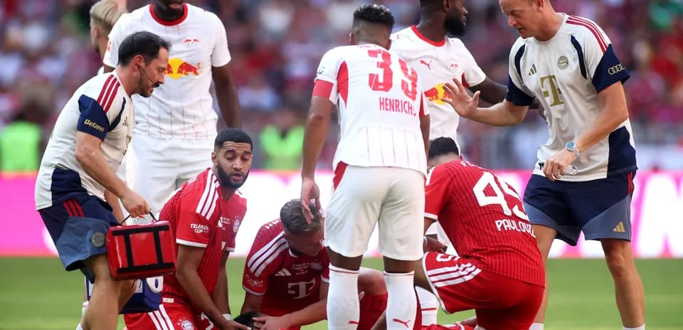 Players and medical staff attending to injured player