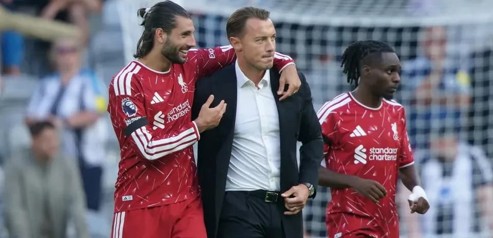Liverpool players celebrating with their manager after match