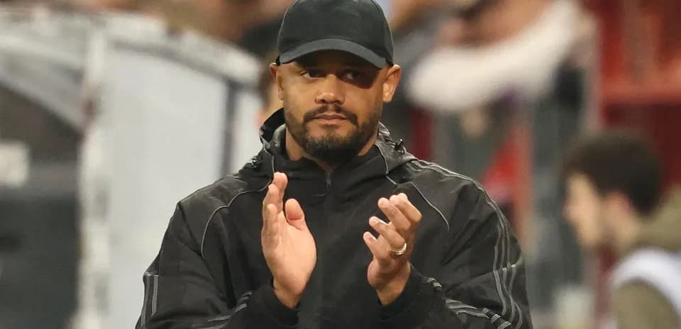 Coach applauding during a match at the stadium