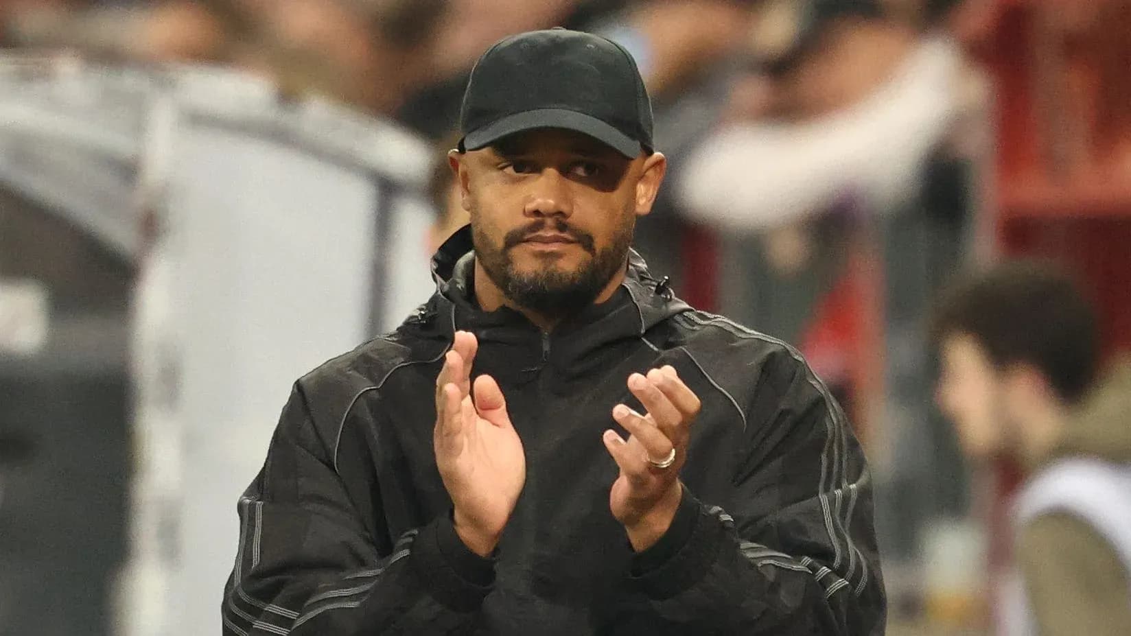 Coach applauding during a match at the stadium