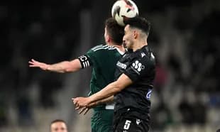 Players contesting a header during PAOK match