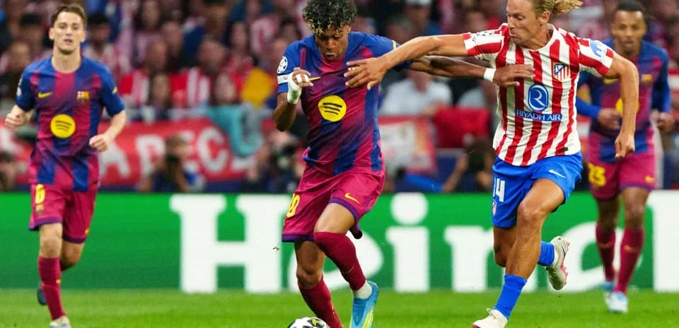 Atletico Madrid player challenging Barcelona forward