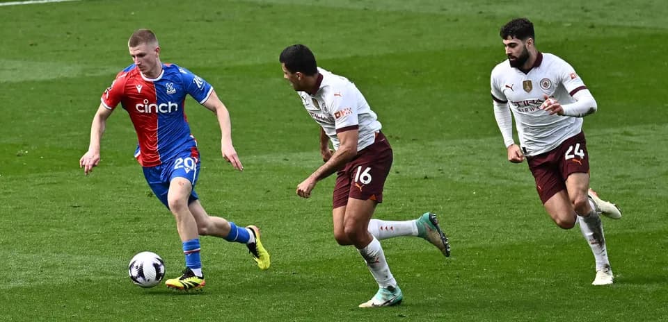Player dribbling the ball with defenders in pursuit