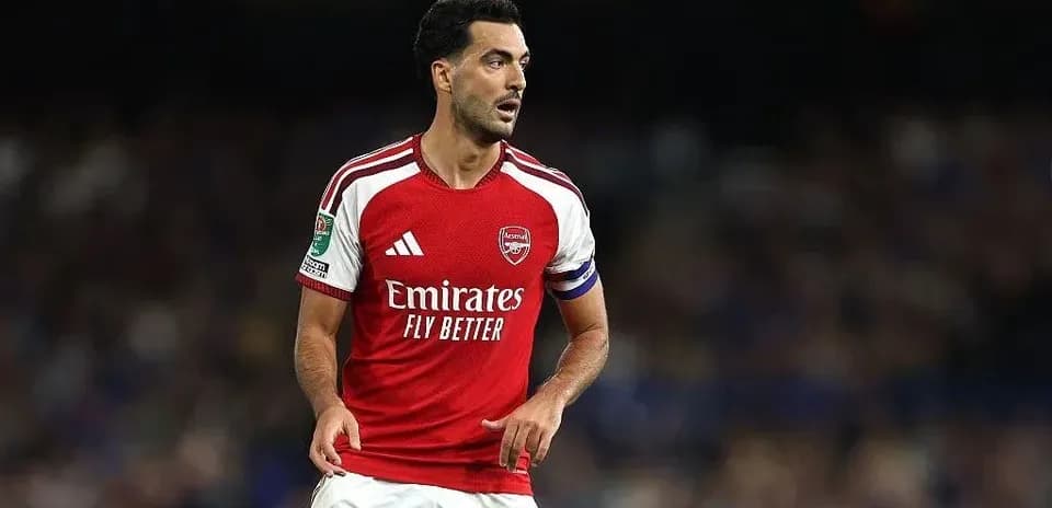 Player wearing Arsenal kit during match action