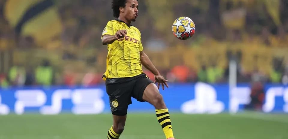 Player in yellow jersey controlling the ball during match