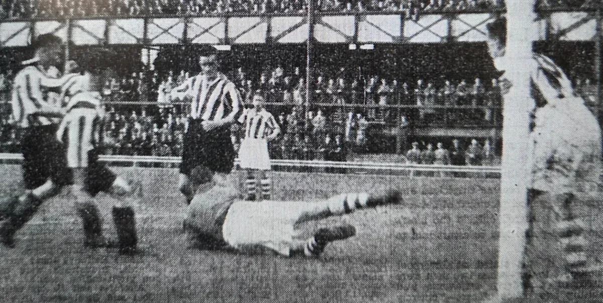 Players contesting near the goal during a match